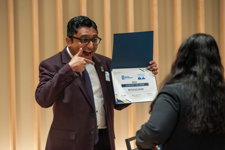 Graduate of Leadership Fort Wayne holding certificate